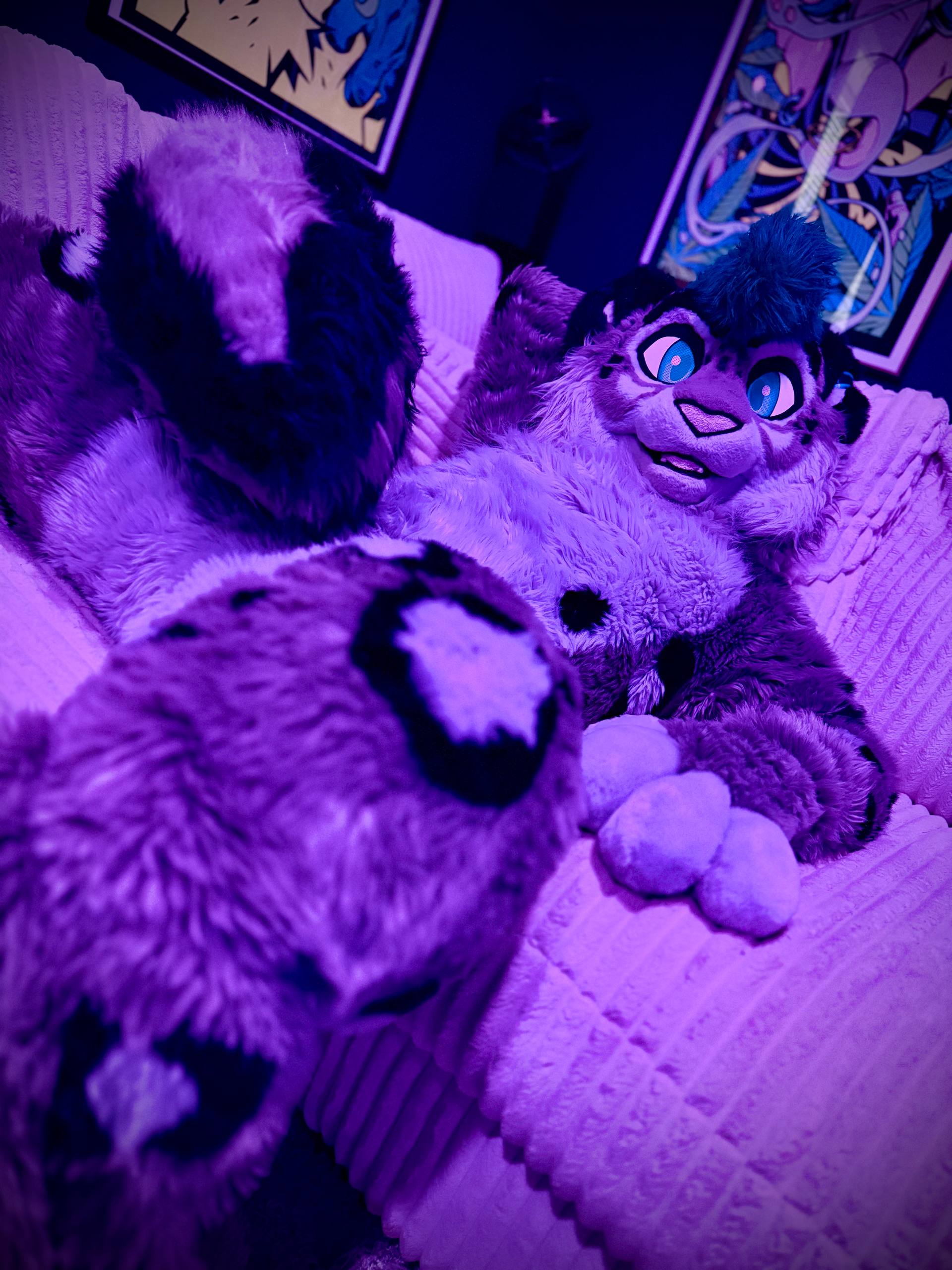Costumed character relaxing in violet light